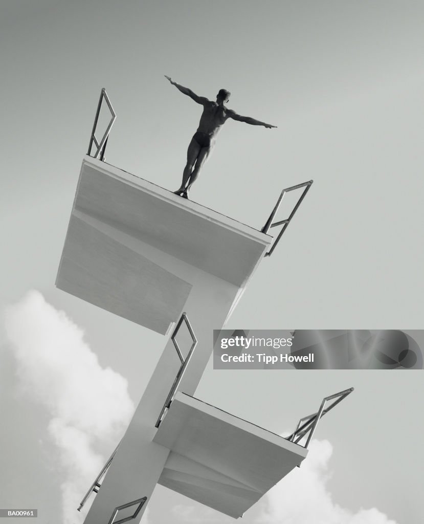 Man about to dive from diving board backward (B&W)