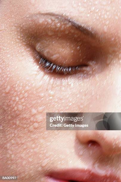 woman with eyes closed with water on face, close-up - beauty skincare stock pictures, royalty-free photos & images
