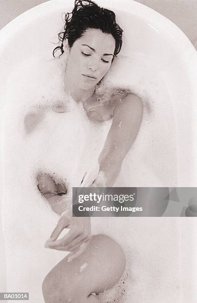 woman relaxing in foam bath, overhead view - baignoire sur pieds photos et images de collection