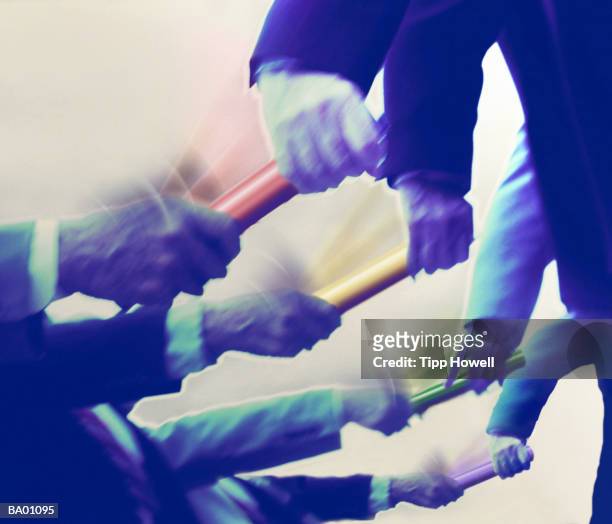 businessmen exchanging batons, close up (digital enhancement) - バトン ストックフォトと画像