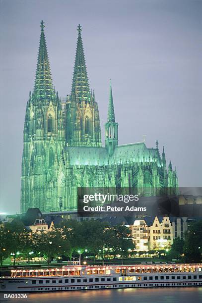 europe, germany, cologne cathedral & boat on rhine at night - cologne germany stock pictures, royalty-free photos & images