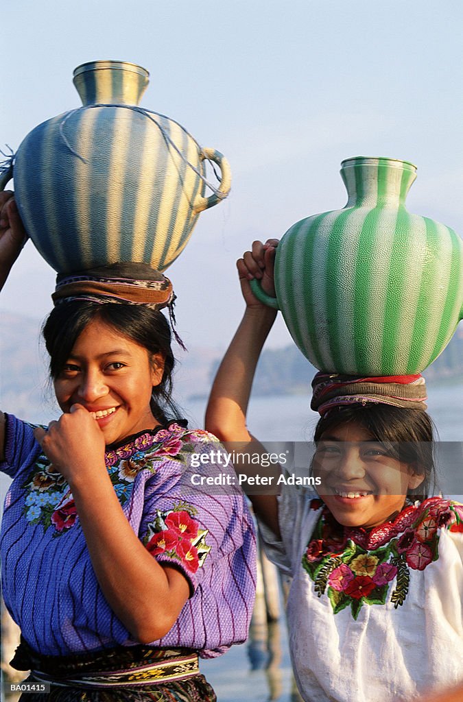 Guatemala, Panajchel, teenage girls carrying water pots