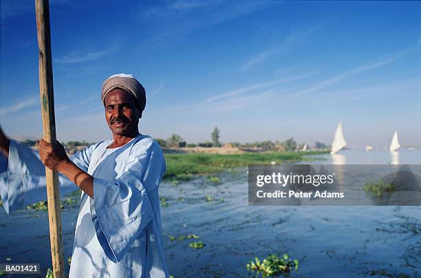 egypt, felluca boatman floating on nile river - nile river stock pictures, royalty-free photos & images