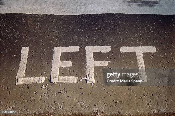 'left' sign painted on road, close-up (b&w) - maria stockfoto's en -beelden