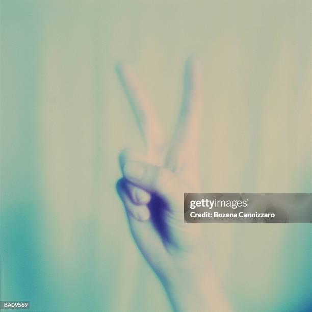 hand making peace sign, close up (cross-processed, soft focus) - cross processed imagens e fotografias de stock