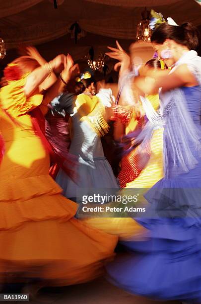 flamenco dancers at fair (blurred motion) - flamencos fotografías e imágenes de stock
