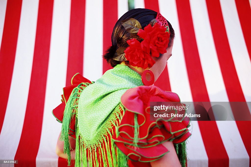 Flamenco dancer at fair, rear view