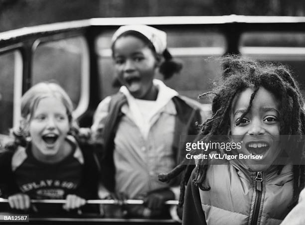 children (7-10) in open top bus (focus on child in foreground, b&w) - top 10 stock-fotos und bilder