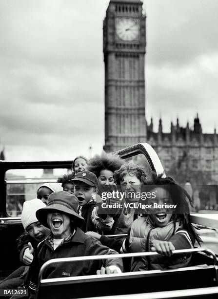 children (6-10) in double decker bus, cheering, portrait (b&w) - decker stock pictures, royalty-free photos & images