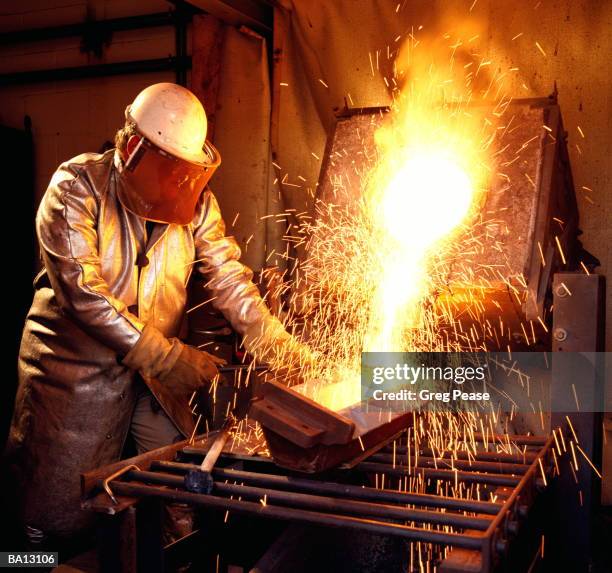 workman wearing safety mask, melting scrap metal - "greg pease" stock pictures, royalty-free photos & images