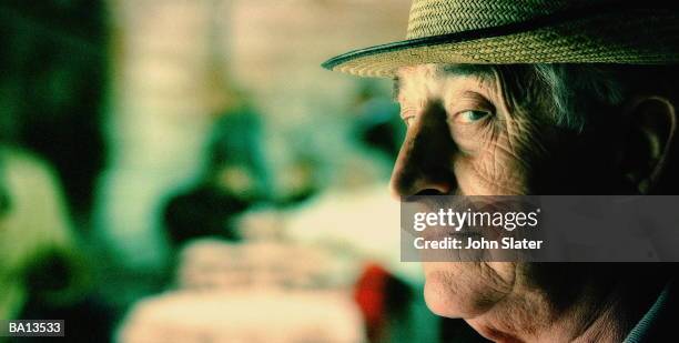 mature man looking out corner of eye, profile, close-up - grumpy old man stock pictures, royalty-free photos & images