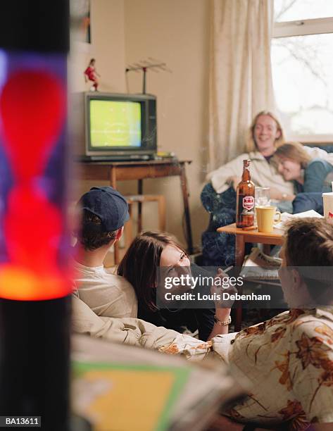 group of young people watching sport on television - television set smoke stock pictures, royalty-free photos & images