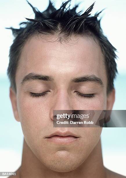 young man with spiked hair, eyes closed, close-up - spiked stock pictures, royalty-free photos & images