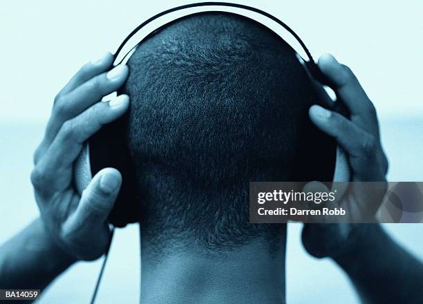young man wearing headphones, rear view, close-up (b&w) - loud man imagens e fotografias de stock
