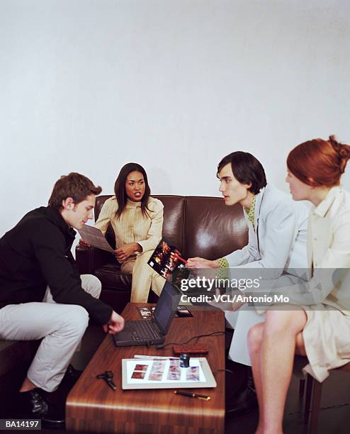 young businesspeople having discussion on sofa - antonio stock pictures, royalty-free photos & images