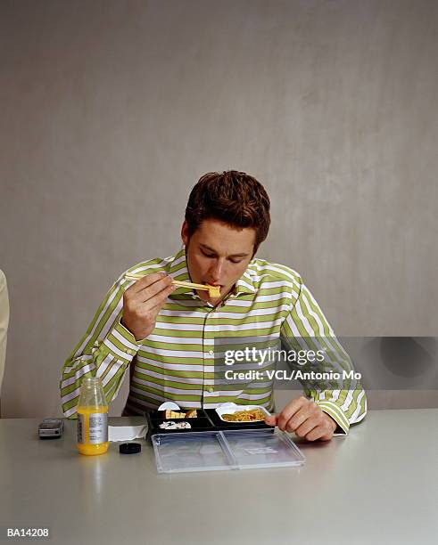 man eating sushi with chopsticks - antonio stock pictures, royalty-free photos & images