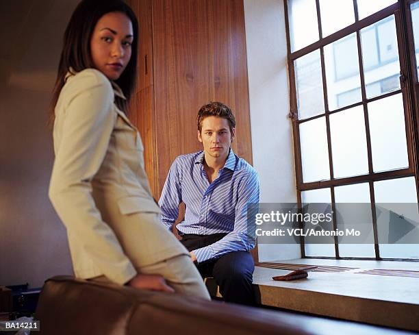 businesswoman and man near window, portrait - antonio stock pictures, royalty-free photos & images