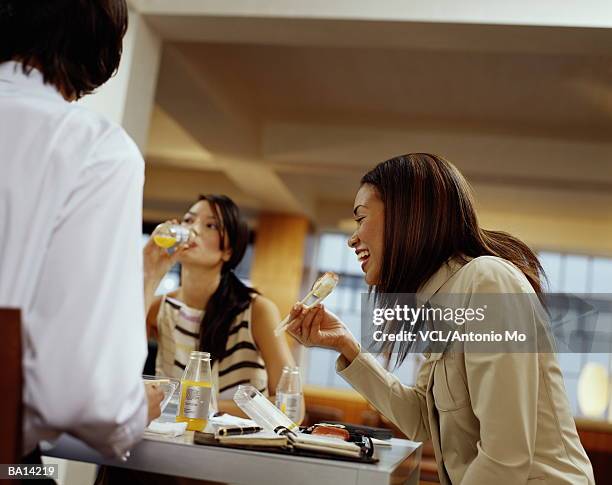 two women and man eating sushi - antonio stock pictures, royalty-free photos & images