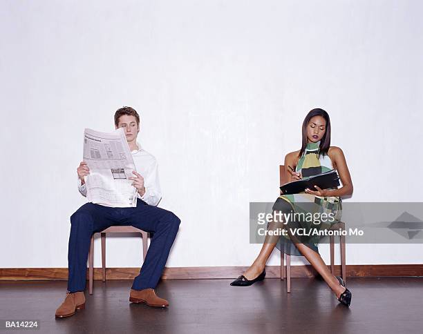 man and woman in chairs - antonio stock pictures, royalty-free photos & images