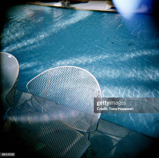 chairs and table by side of swimming pool - hopewell stock pictures, royalty-free photos & images