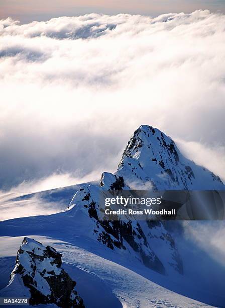 clouds around snow covered alps - ross woodhall stock-fotos und bilder