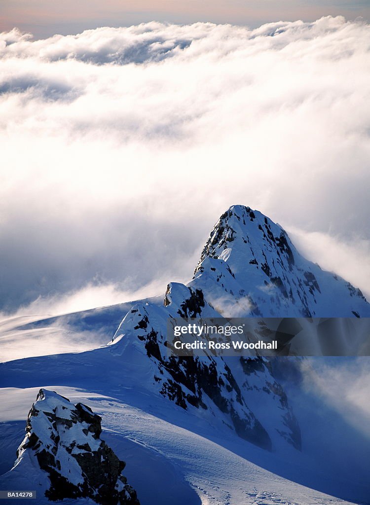 Clouds around snow covered Alps