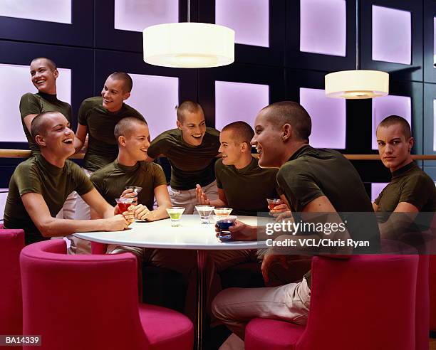 group of men having drinks (digital composite) - clonación fotografías e imágenes de stock