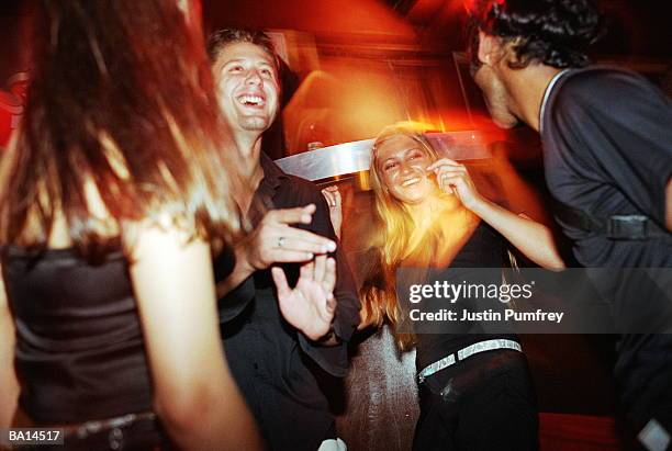 group of friends dancing in club, low angle view - disco dancing stock pictures, royalty-free photos & images