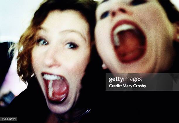 two women with mouths wide open - crosby imagens e fotografias de stock