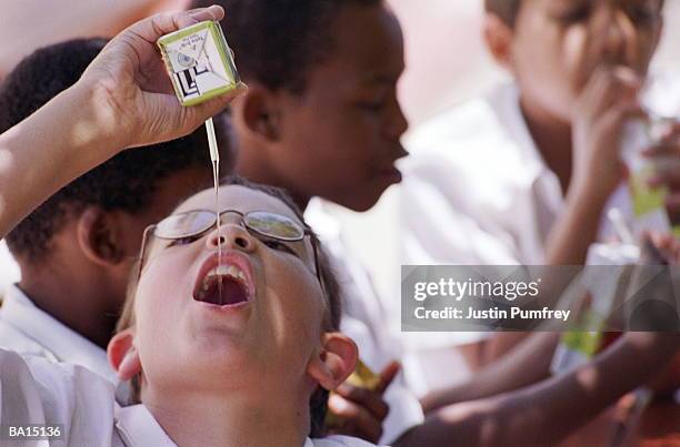 schoolboys (10-12) drinking from cartons, focus on boy in foreground - juice box stock pictures, royalty-free photos & images