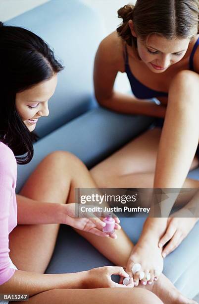 two teenage girls (16-18) painting toenails, elevated view - teen girls toes stock pictures, royalty-free photos & images