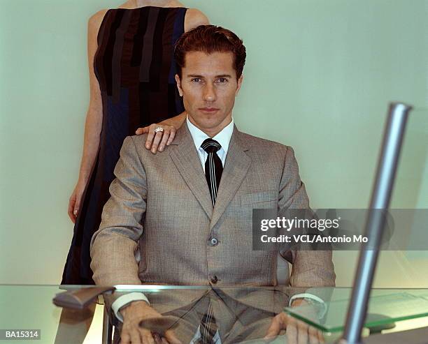 businessman at desk, woman's hand on shoulder, portrait - antonio stock pictures, royalty-free photos & images