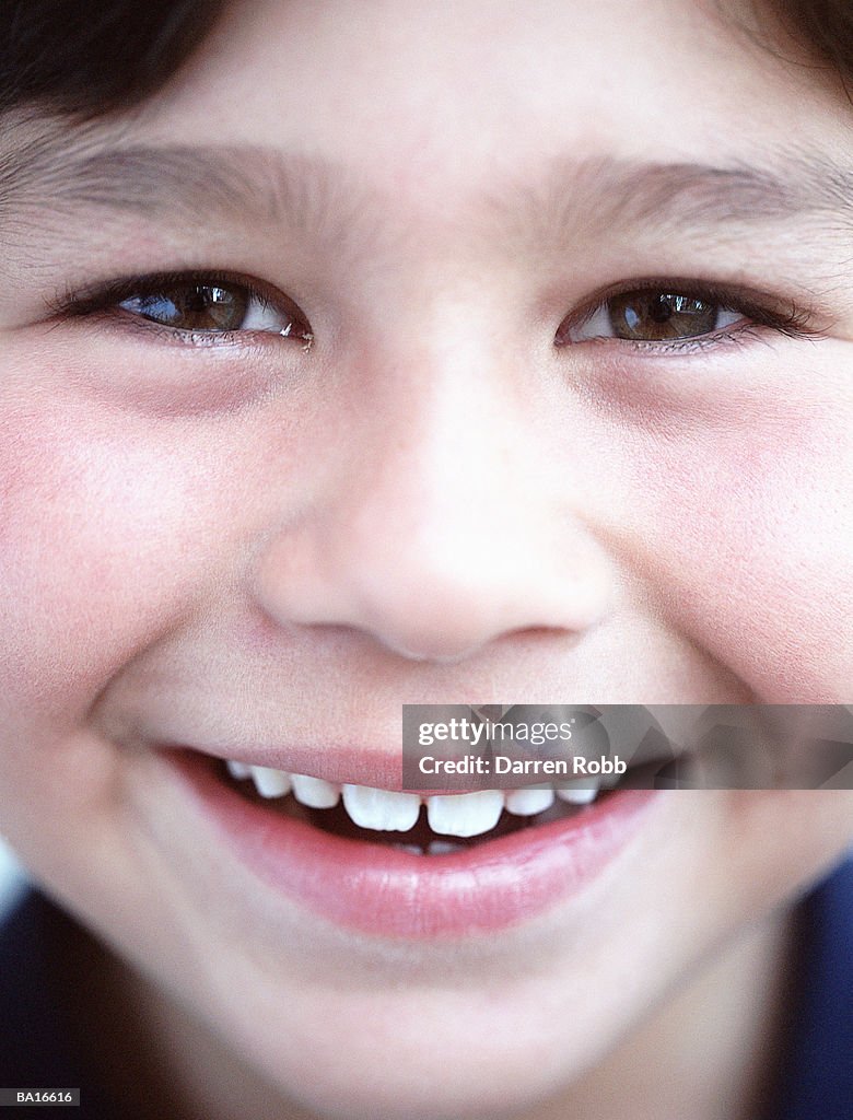 Boy (6-8) smiling, portrait, close-up
