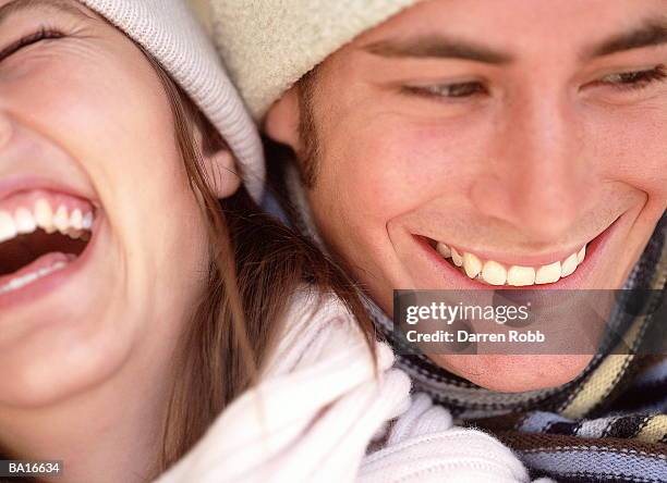 young couple wearing hats and scarves laughing, close-up - 07 stock pictures, royalty-free photos & images