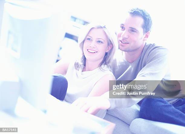 couple using home pc (cross-processed) - cross processed imagens e fotografias de stock