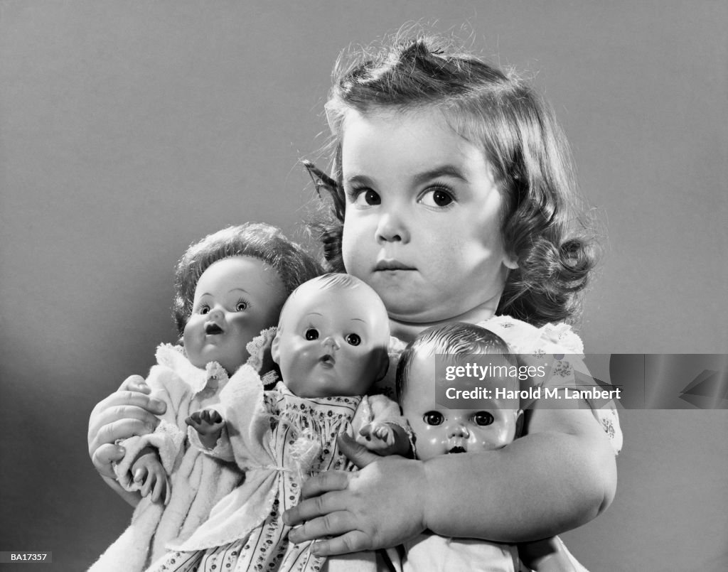 Girl (2-4) holding dollies, portrait (B&W)