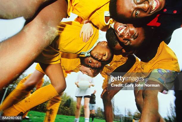 young boys (10-12) playing rugby, low view through scrum (ehancement) - face off sports play stock pictures, royalty-free photos & images