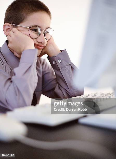 boy (8-10) at computer, head in hands - adult imitation stock pictures, royalty-free photos & images