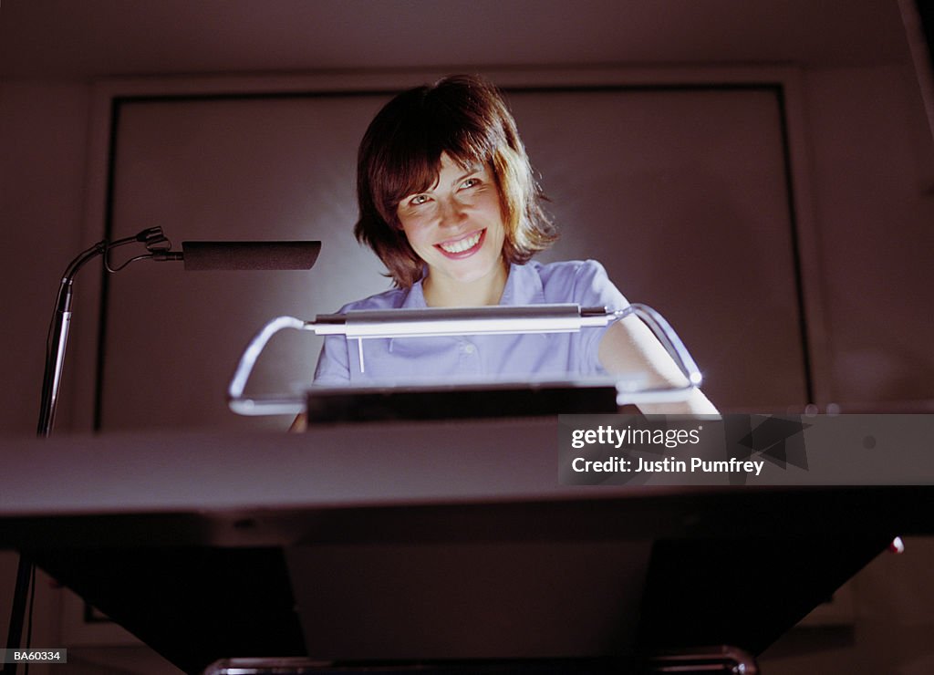 Woman smiling at podium