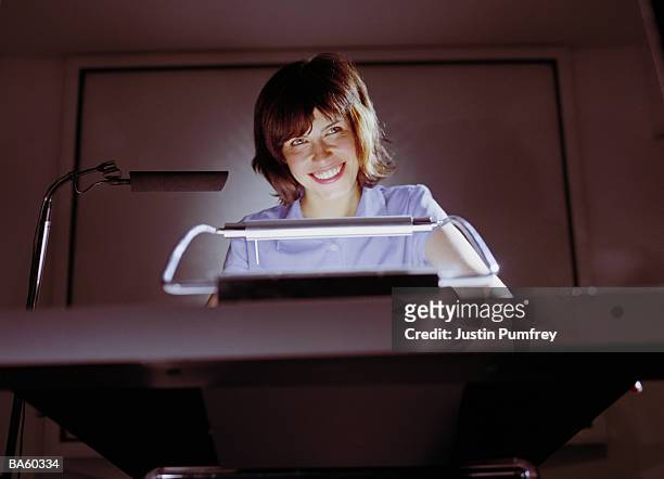 woman smiling at podium - justin stock pictures, royalty-free photos & images