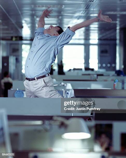 man celebrating in office - kantoorclown stockfoto's en -beelden