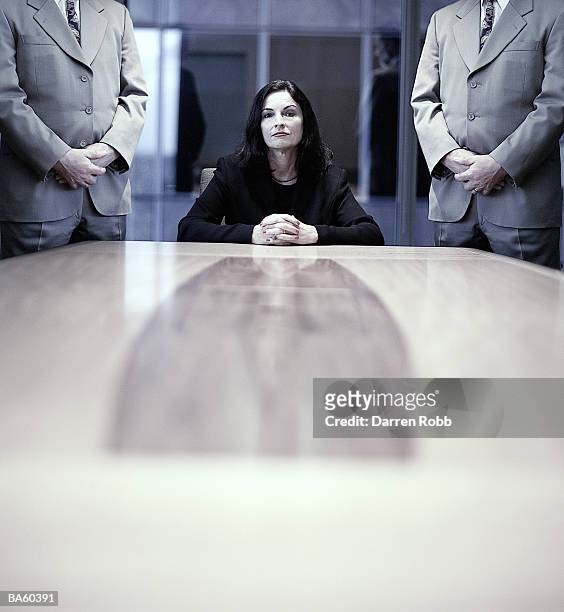 businesswoman at conference table, businessman standing, portrait - female with group of males stock-fotos und bilder
