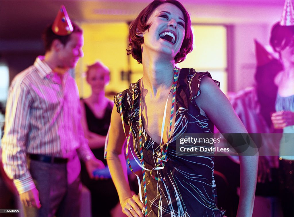 Woman laughing at office party, close-up