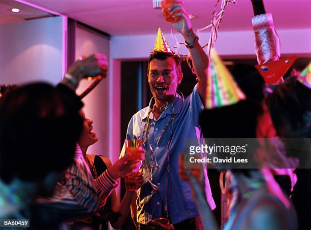 group of people toasting at office party - fiesta en la oficina fotografías e imágenes de stock