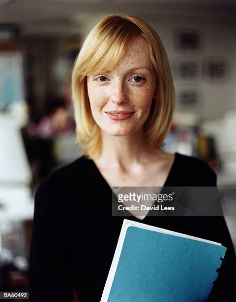 woman holding file, close-up, portrait - teacher portrait stock pictures, royalty-free photos & images