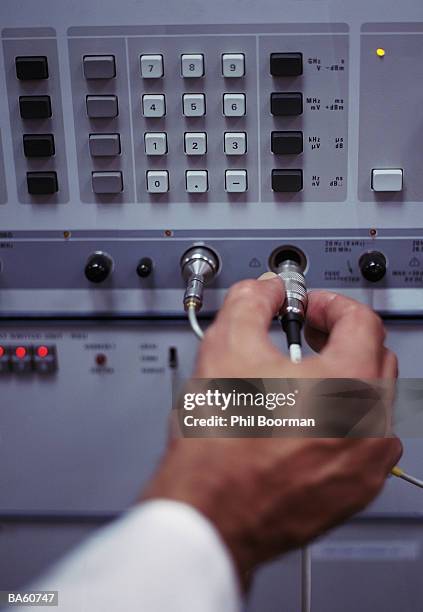 male technician connecting lead to machine, close-up - phil stock pictures, royalty-free photos & images