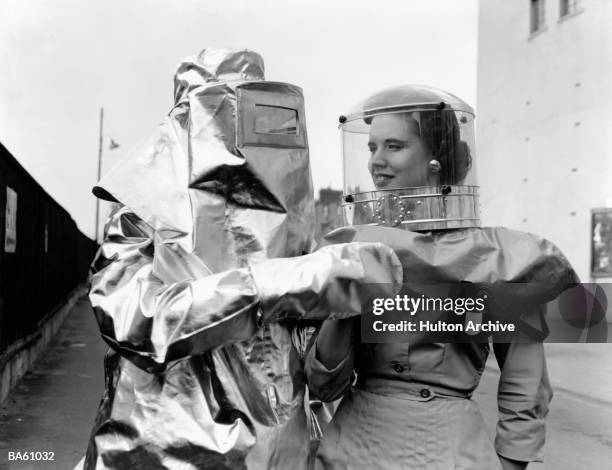 Audrey Lambert models a domed polythene helmet for