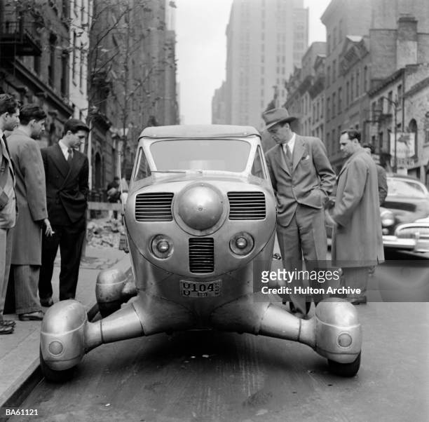 Group of men looking over a futuristic car parke