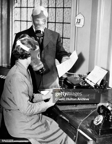 Whitehall, London, England, Insurance company employees getting accustomed to wearing gas marks while carrying out their normal duties, 20th April...