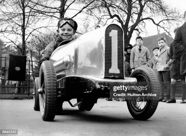 Young Don Banks is the envy of his friends at Charlton Park School, south east London with his miniature sports car. 10th March 1934